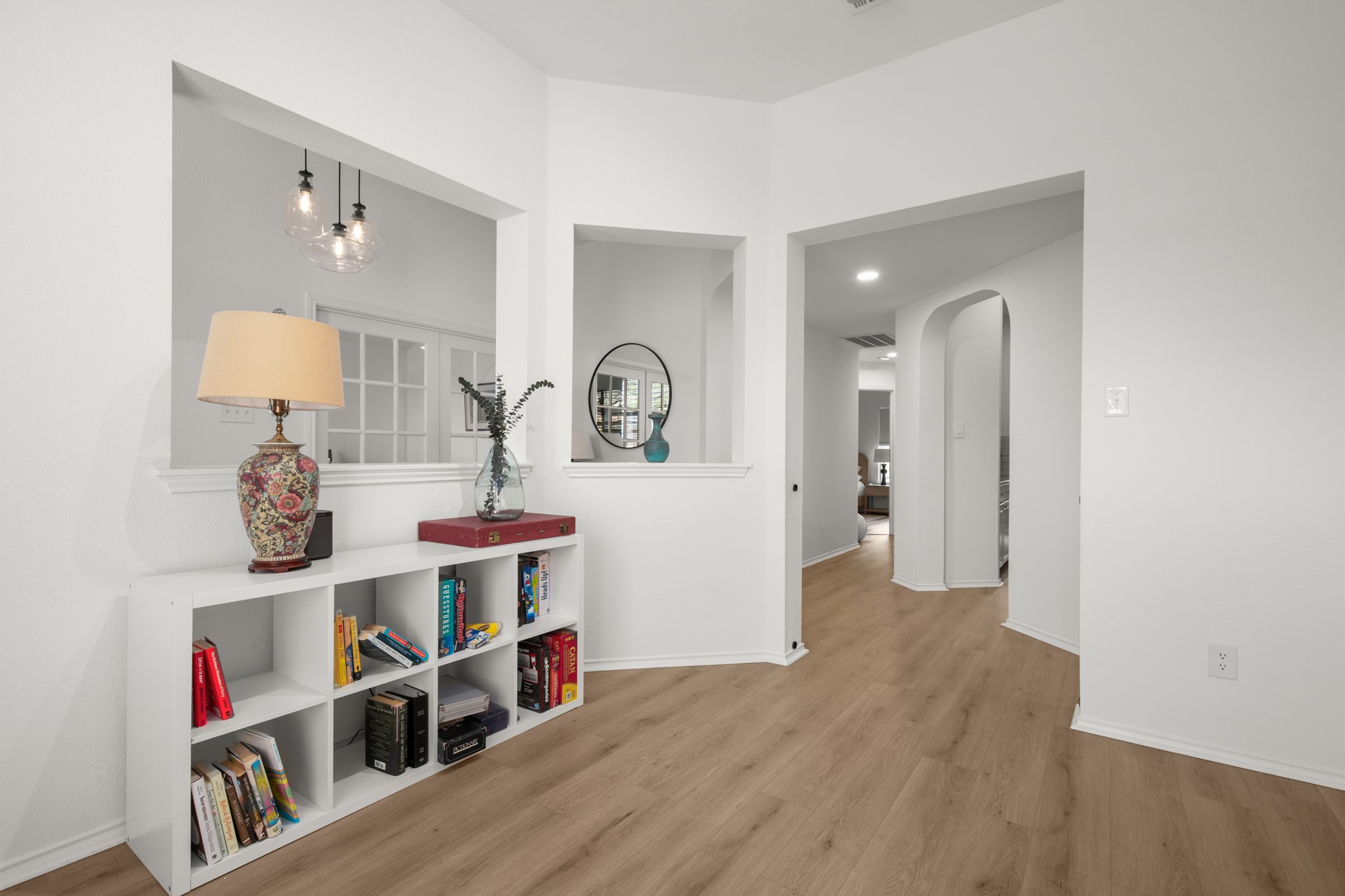 4523 Ramies Run Austin, TX 78749 - Photo 16 of 30 Corridor with light wood-style floors, arched walkways, and recessed lighting