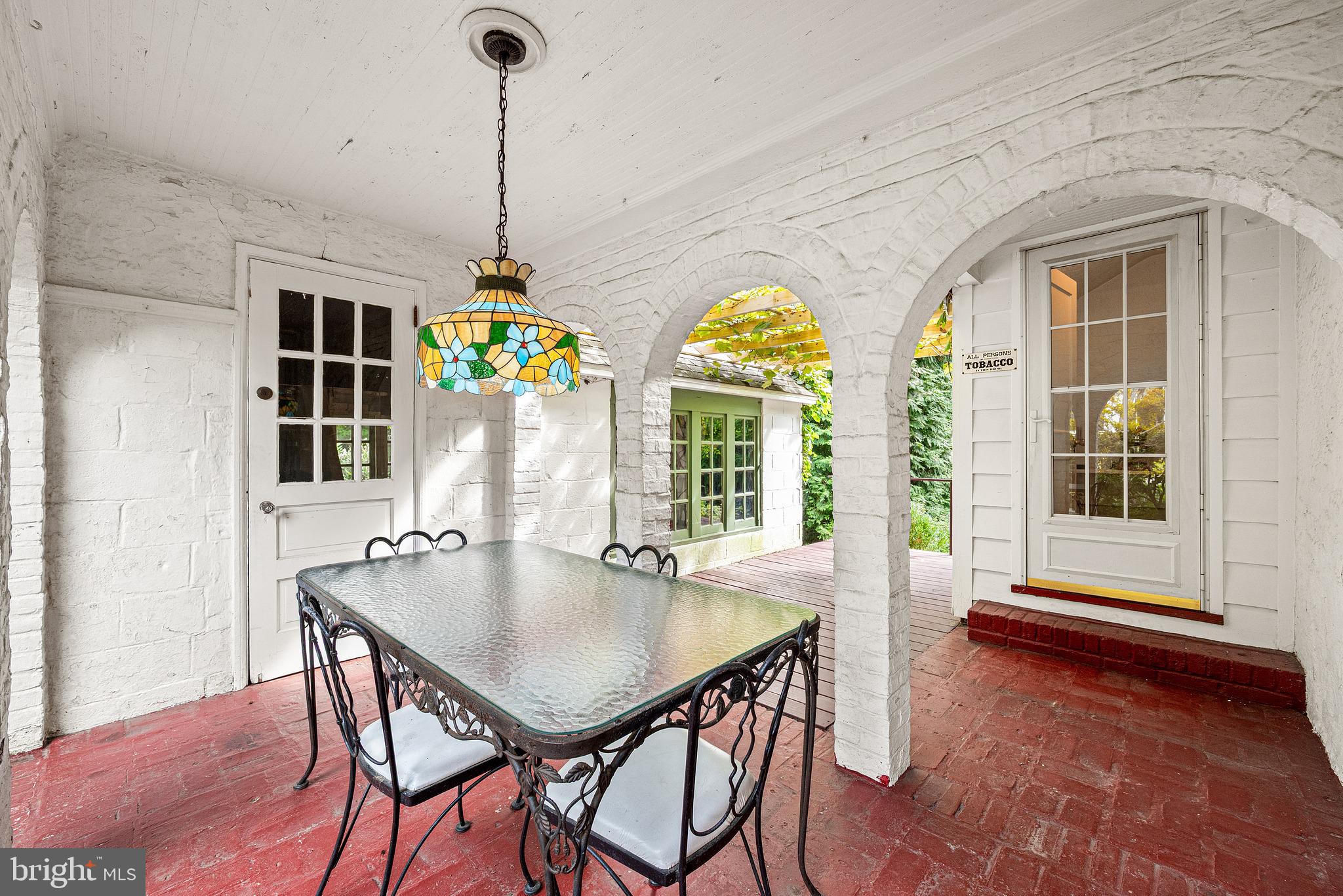 Neo-classical Breezeway Archways connect to Garage