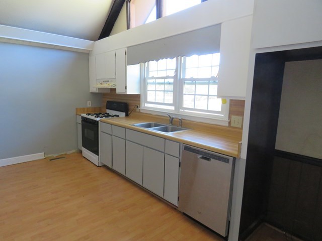 3774 Holley Road Lizella, GA 31052 - Photo 8 of 13 a kitchen with stainless steel appliances a sink stove and cabinets