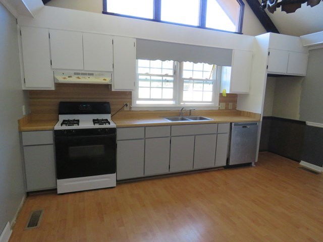 3774 Holley Road Lizella, GA 31052 - Photo 9 of 13 a kitchen with stainless steel appliances a stove a sink and a microwave