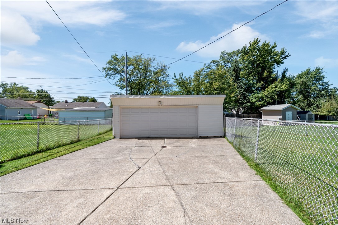 1722 Chelmsford Road Cleveland, OH 44124 - Photo 28 of 34 Garage featuring garage and a lawn