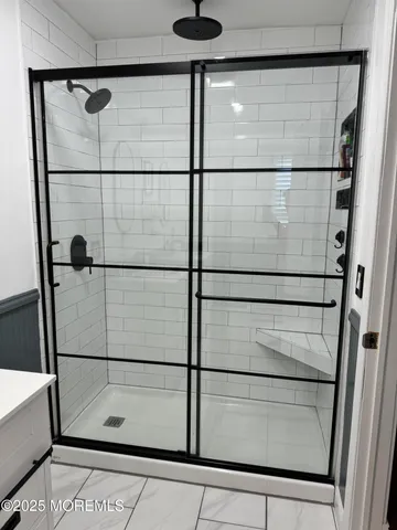 a bathroom with a glass shower door