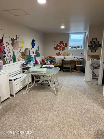 a room with a baby bed furniture and a window