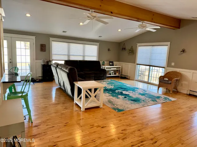 a living room with furniture and a wooden floor