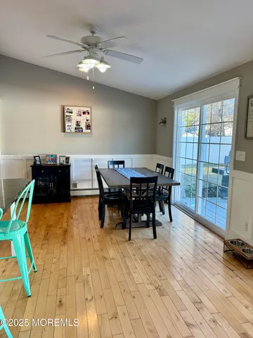 a view of a dining room with furniture a chandelier and wooden floor