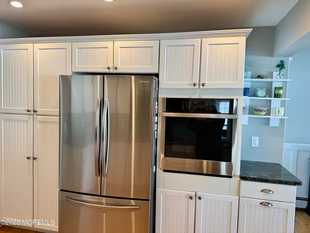 a white refrigerator freezer and a stove sitting inside of a kitchen