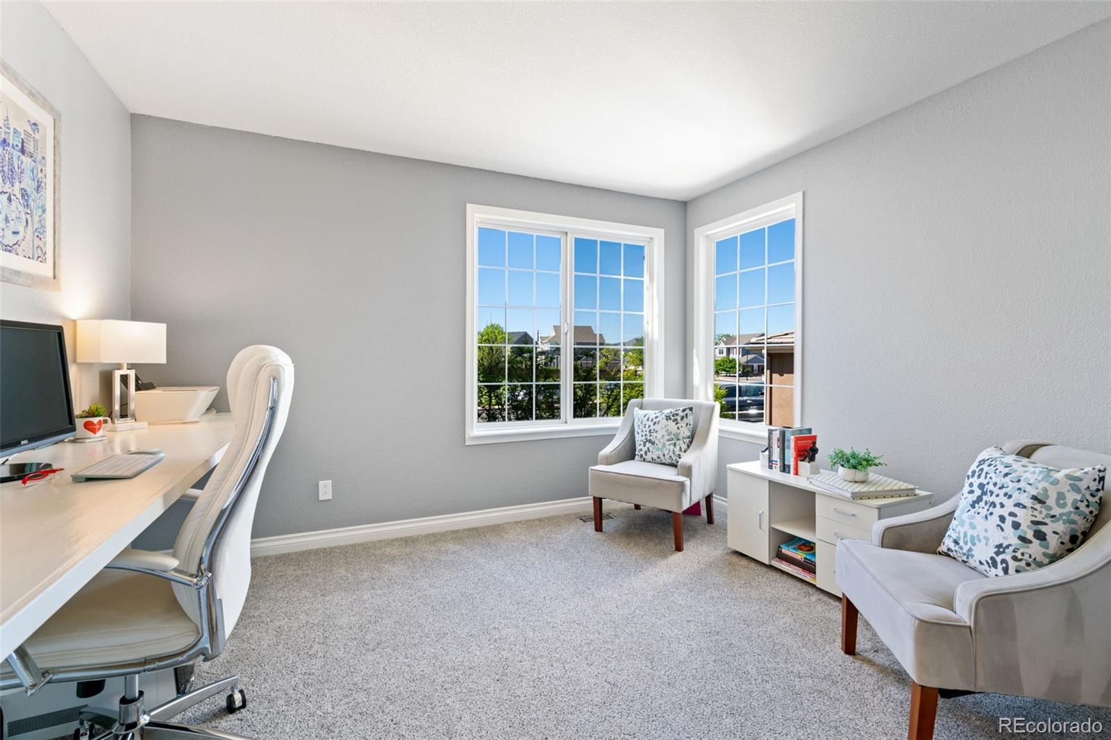 2667 West Bitterroot Place Highlands Ranch, CO 80129 - Photo 20 of 40 a living room with furniture a chair and a large window