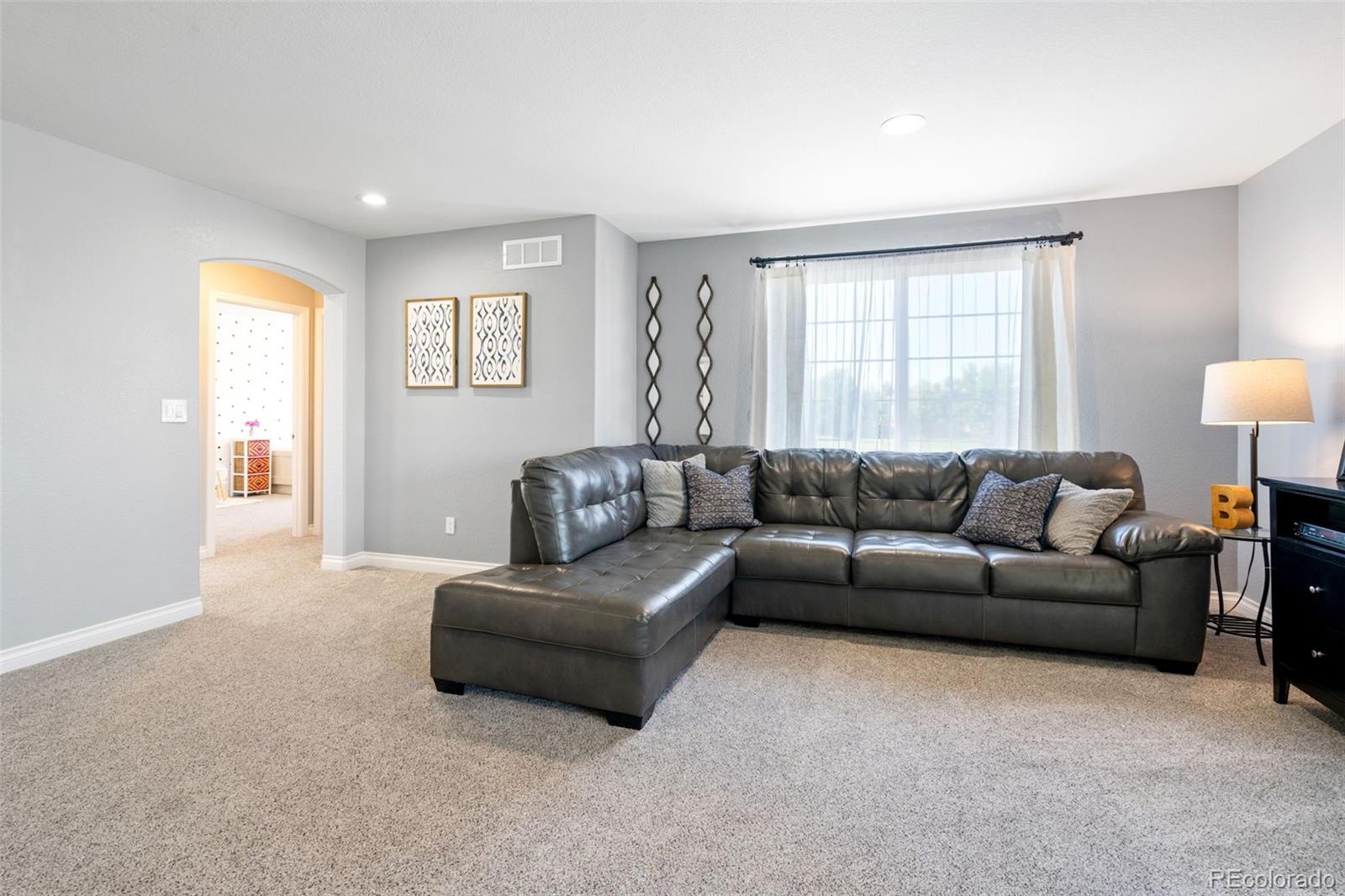 2667 West Bitterroot Place Highlands Ranch, CO 80129 - Photo 21 of 40 a living room with furniture and a window