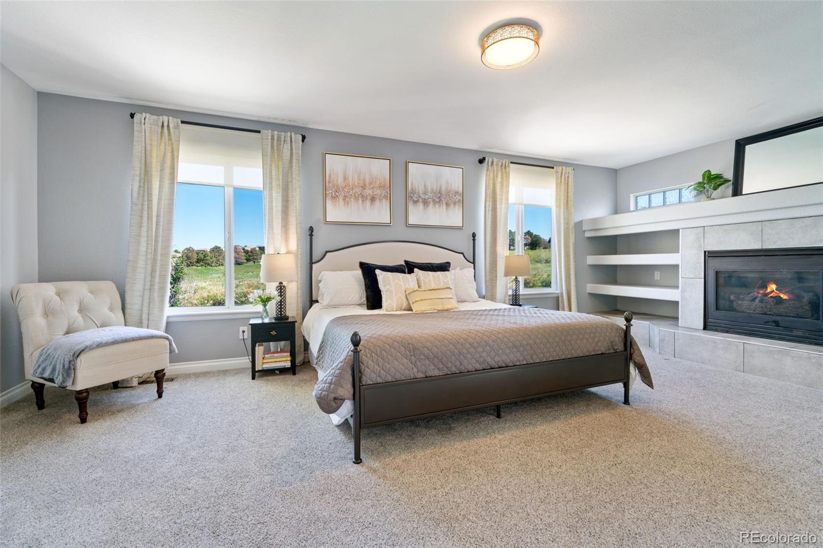 2667 West Bitterroot Place Highlands Ranch, CO 80129 - Photo 23 of 40 a bedroom with a bed and a fireplace
