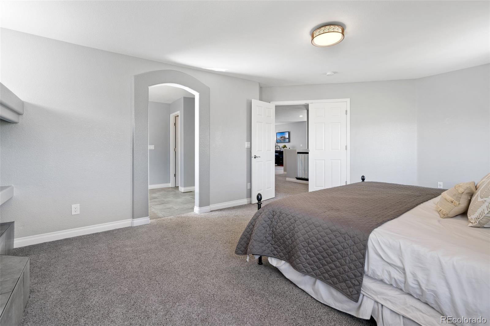 2667 West Bitterroot Place Highlands Ranch, CO 80129 - Photo 24 of 40 a bedroom with a bed and closet