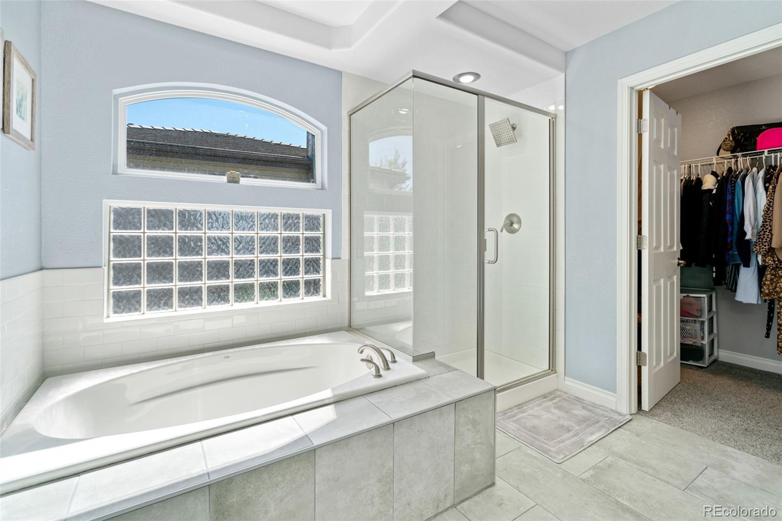 2667 West Bitterroot Place Highlands Ranch, CO 80129 - Photo 26 of 40 a bathroom with a tub sink and a shower