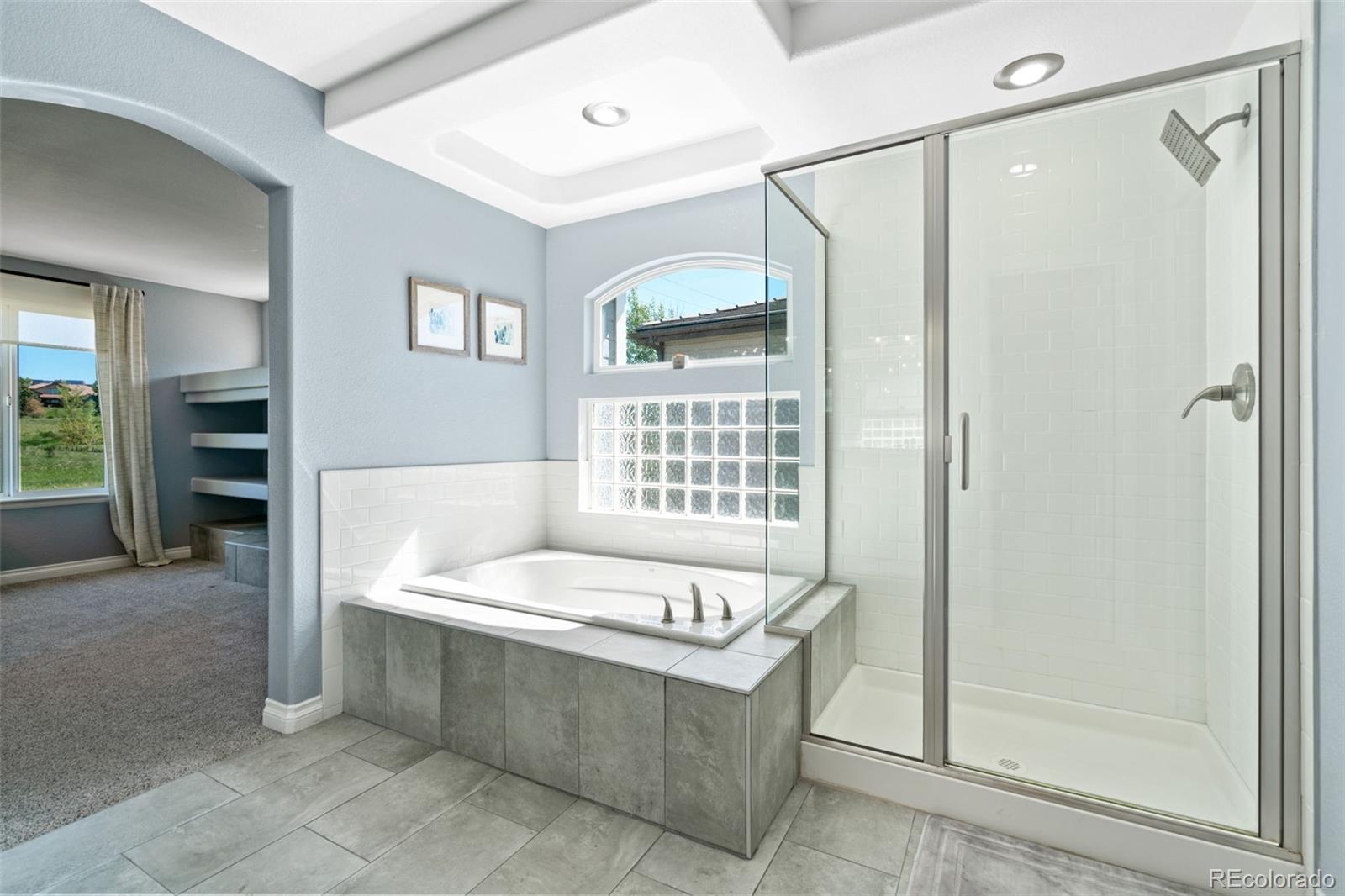 2667 West Bitterroot Place Highlands Ranch, CO 80129 - Photo 28 of 40 a bathroom with a tub a sink and a shower