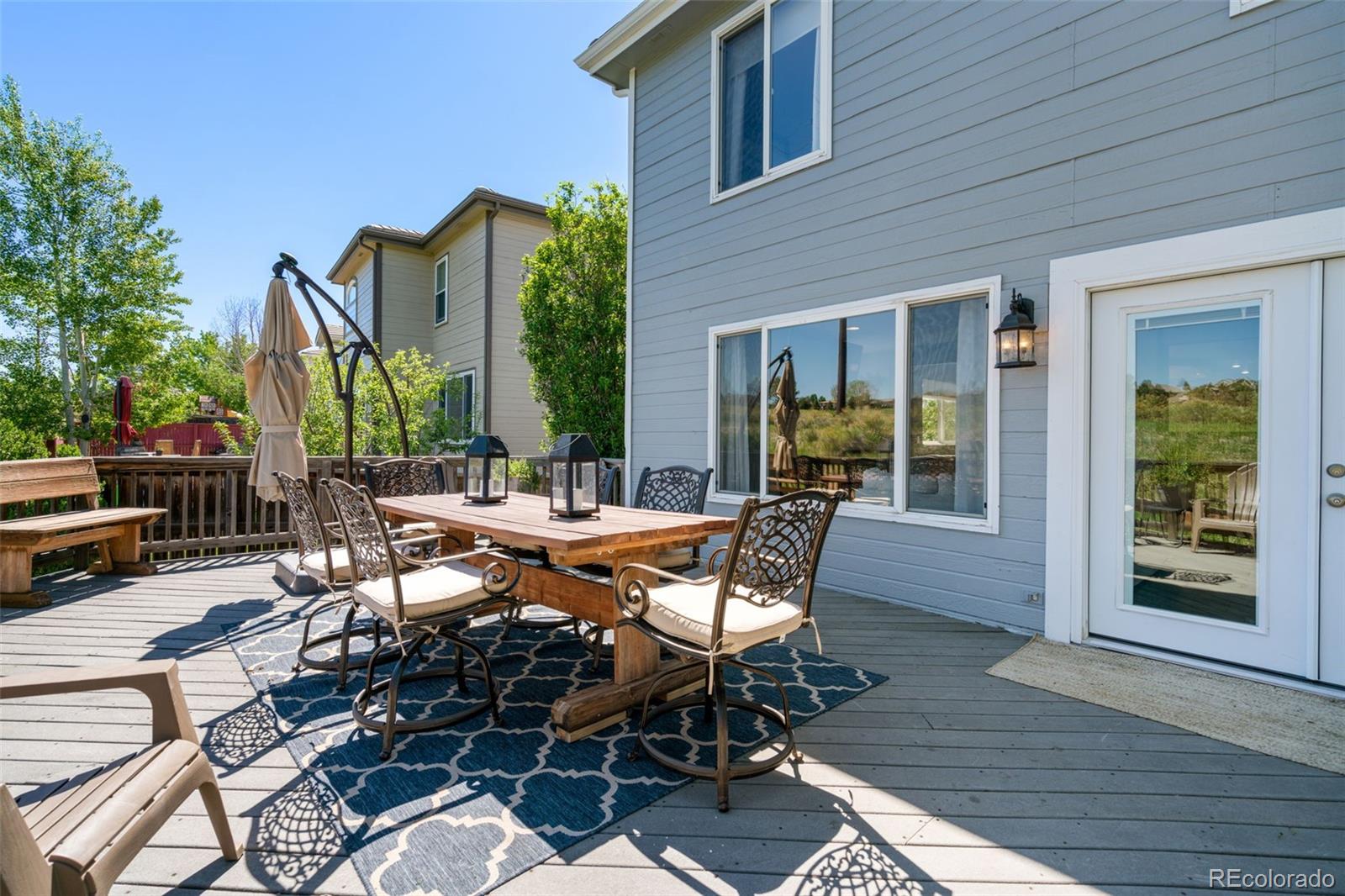 2667 West Bitterroot Place Highlands Ranch, CO 80129 - Photo 34 of 40 a view of a patio with table and chairs and potted plants