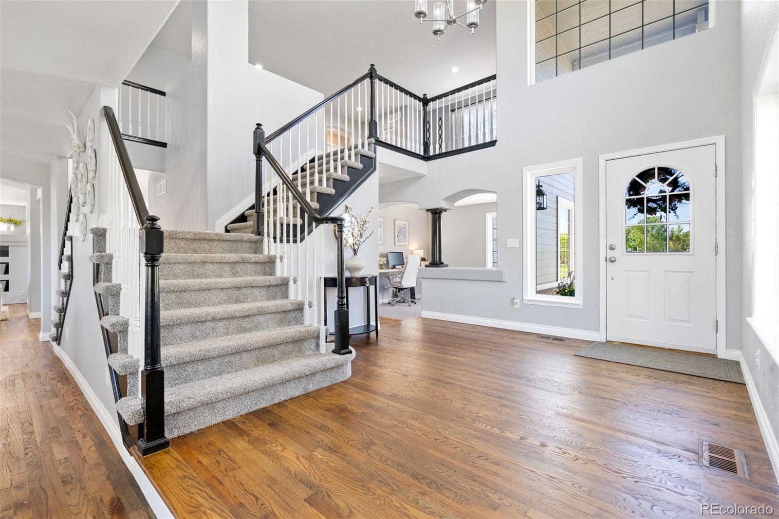 2667 West Bitterroot Place Highlands Ranch, CO 80129 - Photo 4 of 40 a view of entryway and hall with wooden floor