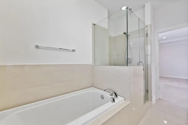 a bathroom with a bathtub and a shower