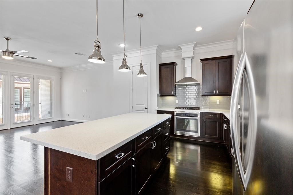 1525 Johnson Street Houston, TX 77007 - Photo 7 of 26 a kitchen with kitchen island a sink stainless steel appliances and cabinets