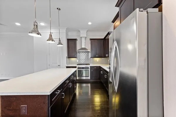 a kitchen with a refrigerator a sink and cabinets