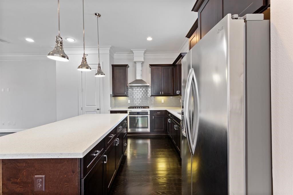 1525 Johnson Street Houston, TX 77007 - Photo 8 of 26 a kitchen with a refrigerator a sink and cabinets