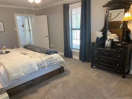 a bedroom with a bed and a mirror