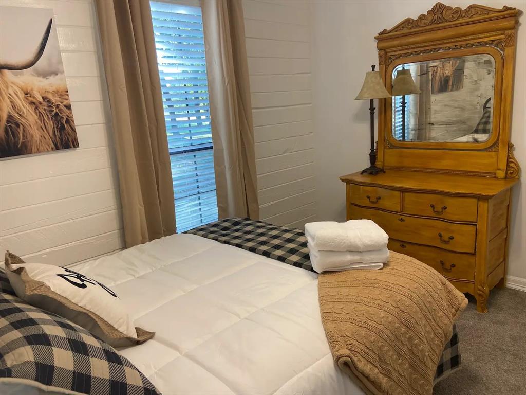 1402 Posey Brewer Road Sunset, TX 76270 - Photo 14 of 19 a bedroom with a bed and wooden floor