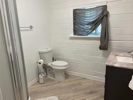 a white toilet sitting next to a bathroom sink