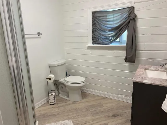 a white toilet sitting next to a bathroom sink