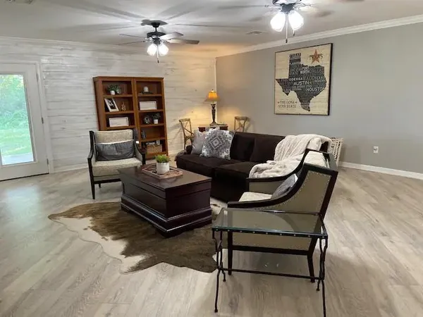 a living room with furniture and a wooden floor