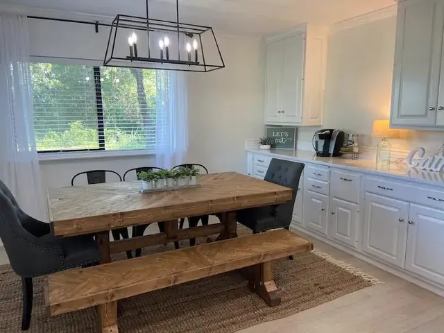 a view of a dining room with furniture window and outside view