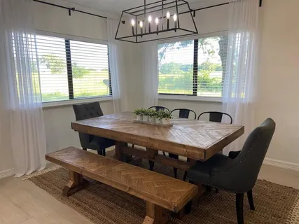 a dining room with furniture a rug and wooden floor