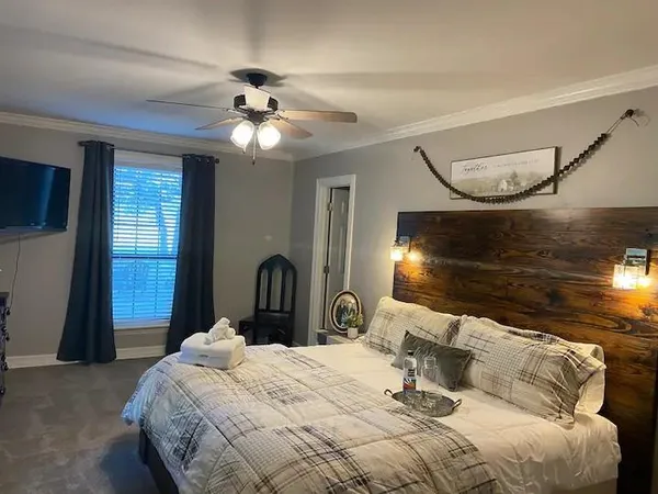 a bedroom with a bed and a chandelier