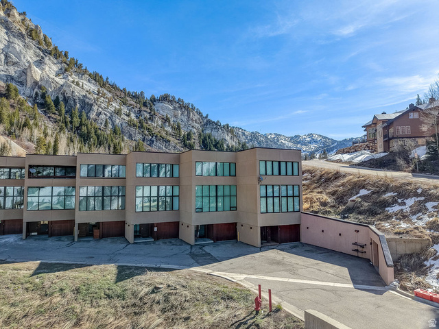 9699 Bypass Road, Unit 5 Alta, UT 84092 - Photo 51 of 54 Contemporary multi-story building featuring extensive window placements, individual garage access, and a mountain backdrop