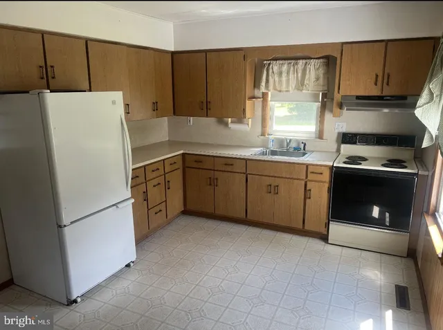 a bathroom with a toilet a sink and a window