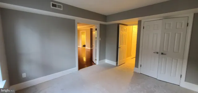 a view of hallway with closet area