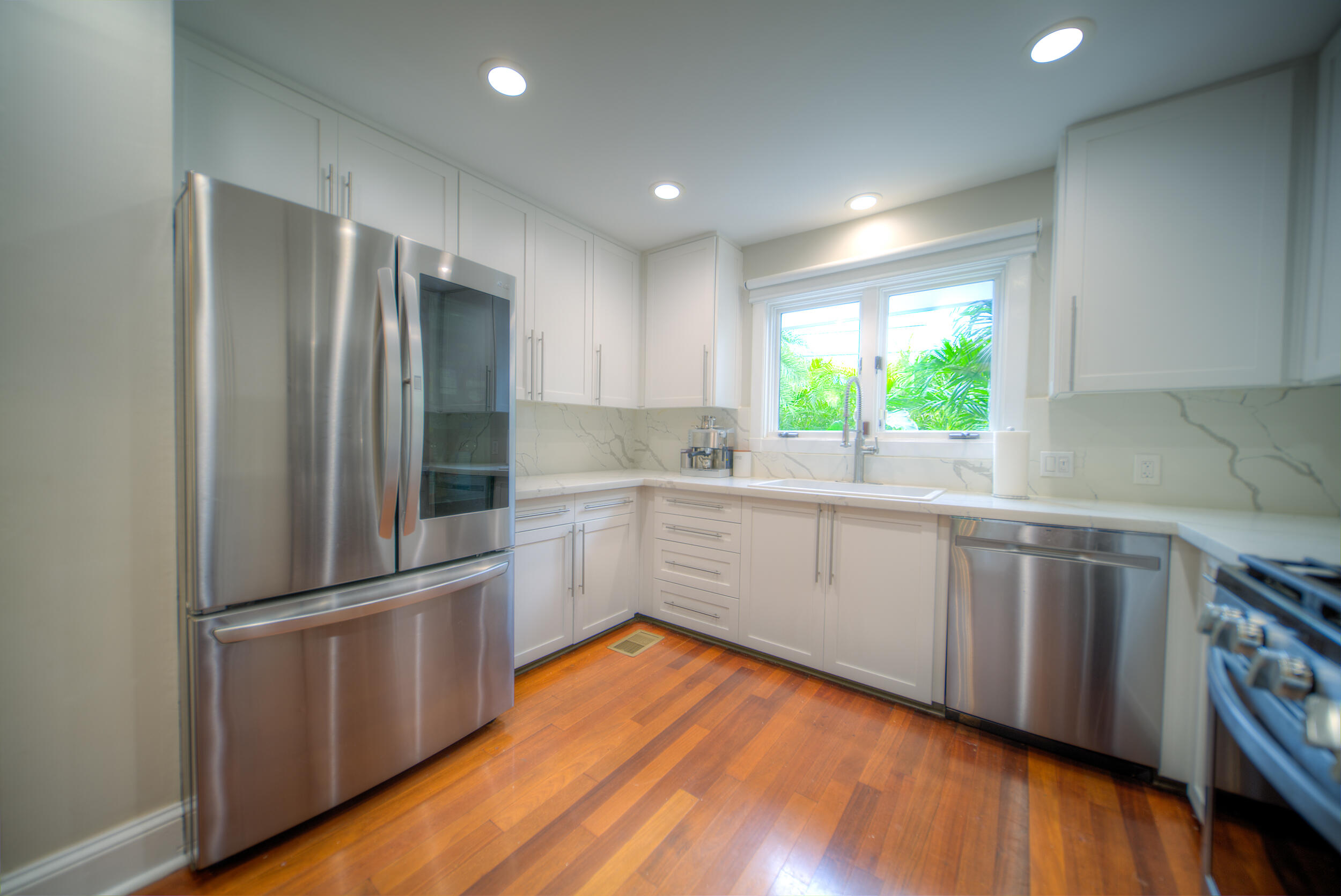 720 Washington Street Key West, FL 33040 - Photo 11 of 33 a kitchen with granite countertop stainless steel appliances a sink and window