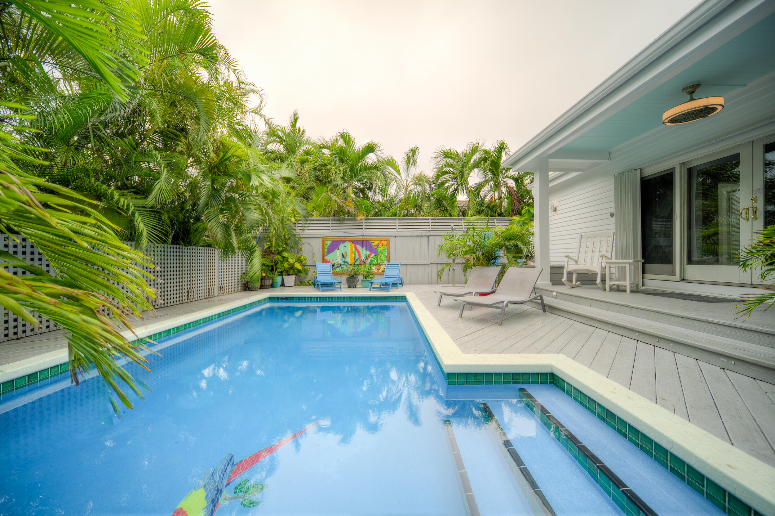 720 Washington Street Key West, FL 33040 - Photo 14 of 33 a view of a balcony with chairs and a potted plant