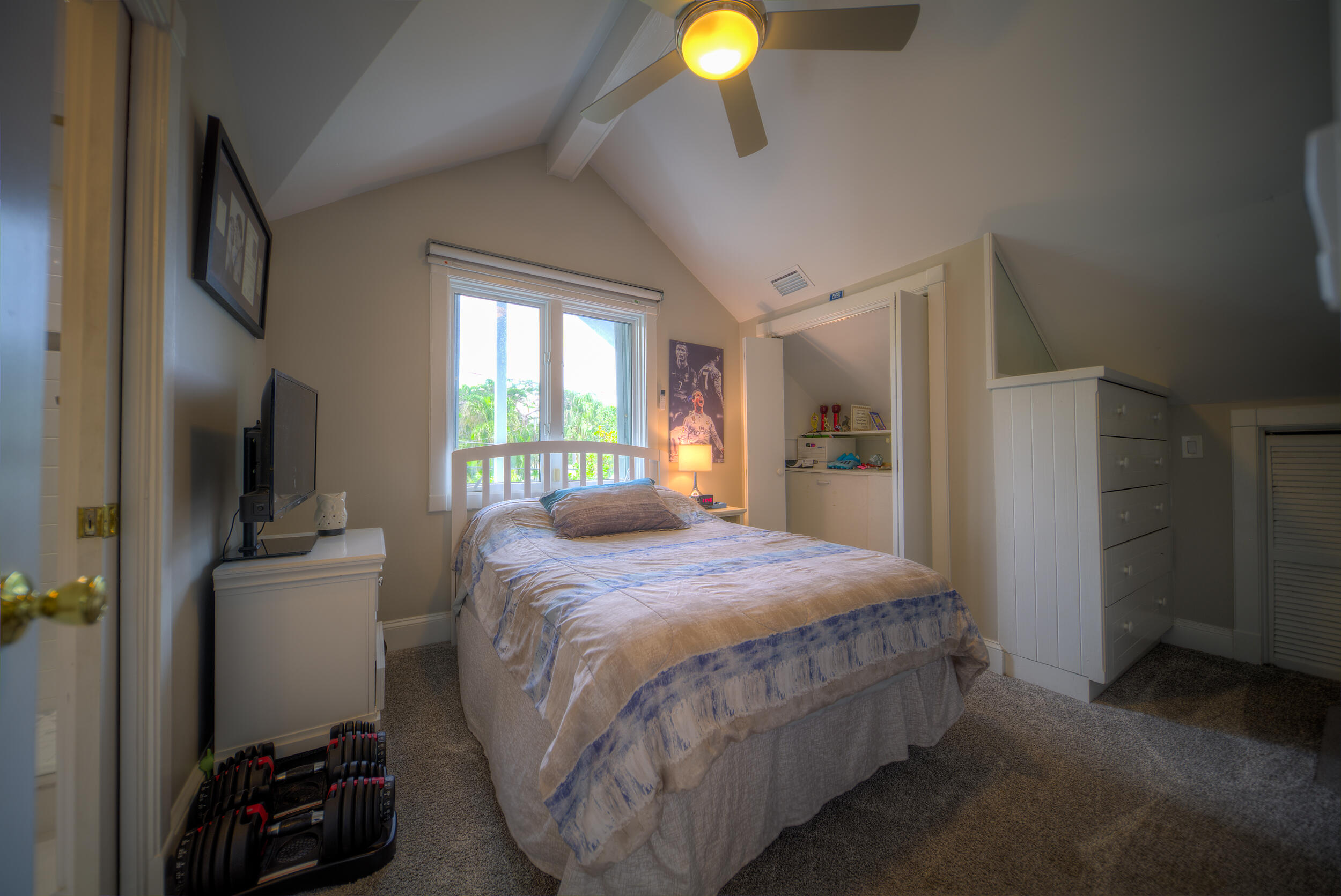 720 Washington Street Key West, FL 33040 - Photo 26 of 33 a bedroom with a bed and a flat tv screen on dresser