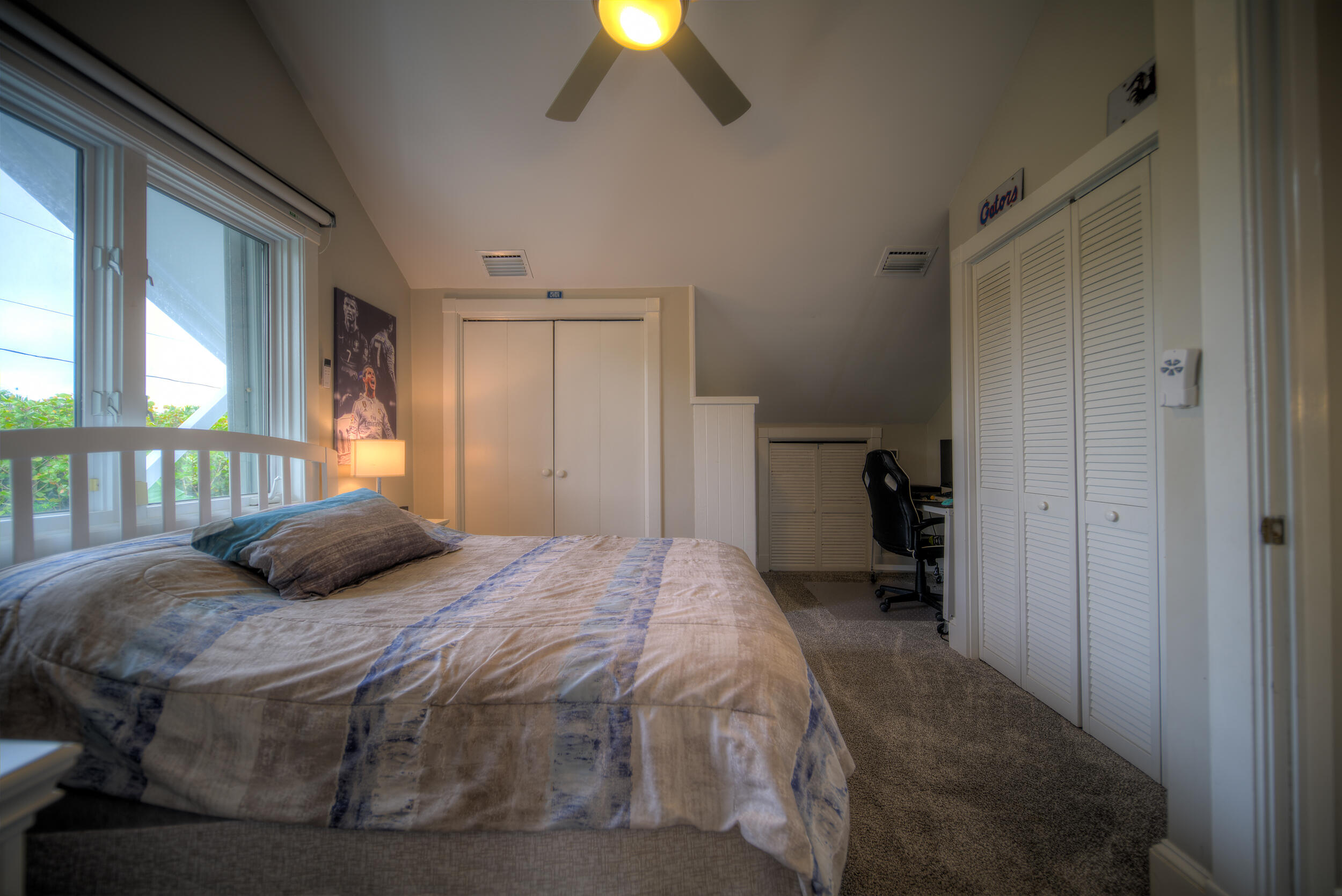 720 Washington Street Key West, FL 33040 - Photo 27 of 33 a bedroom with a bed and a chandelier