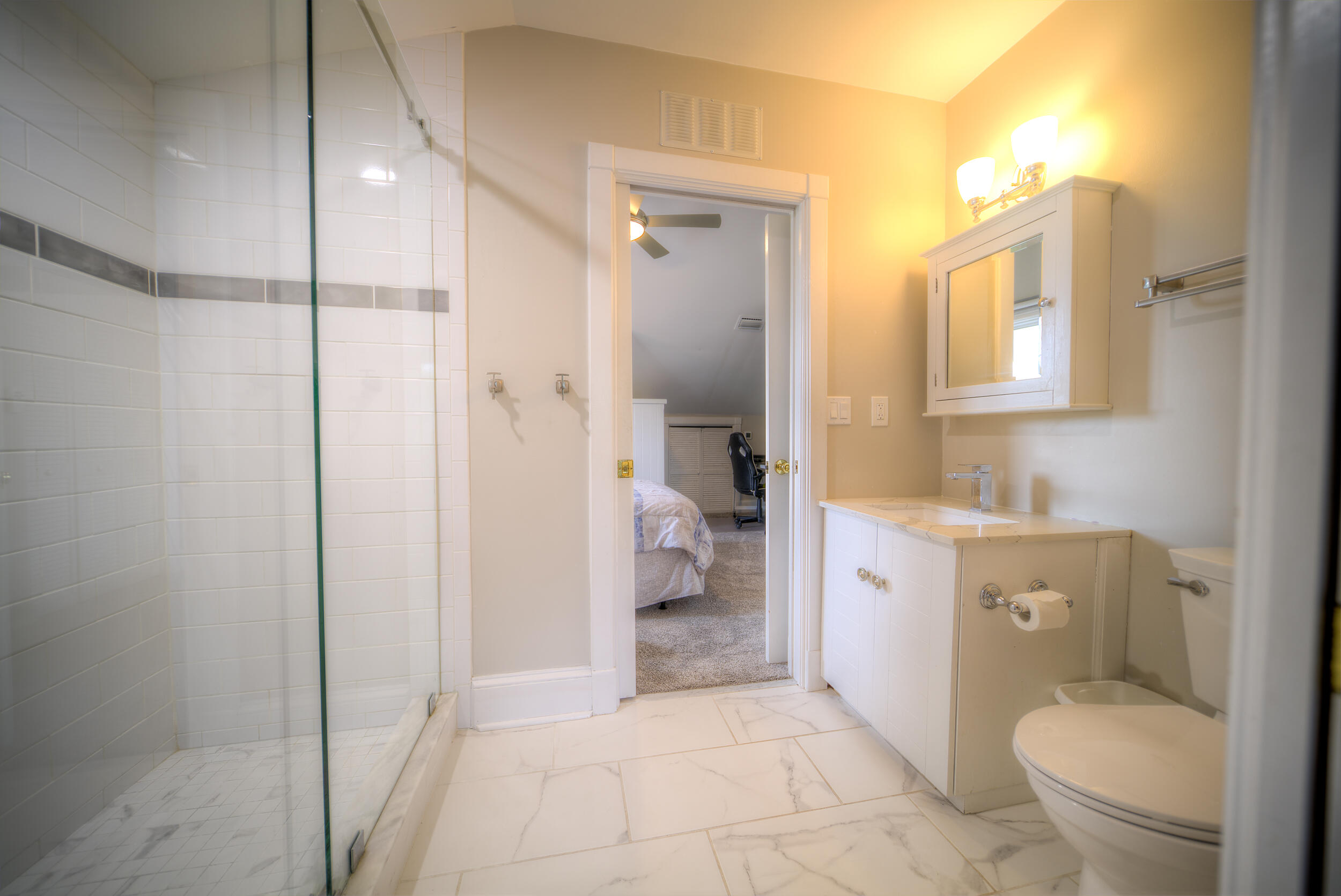 720 Washington Street Key West, FL 33040 - Photo 28 of 33 a bathroom with a granite countertop toilet a sink and a mirror