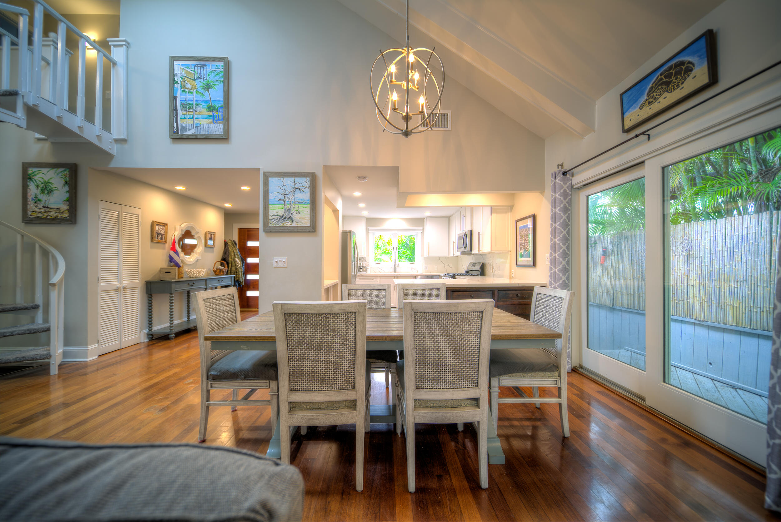 720 Washington Street Key West, FL 33040 - Photo 8 of 33 a dining room with wooden floor a chandelier a wooden table and chairs