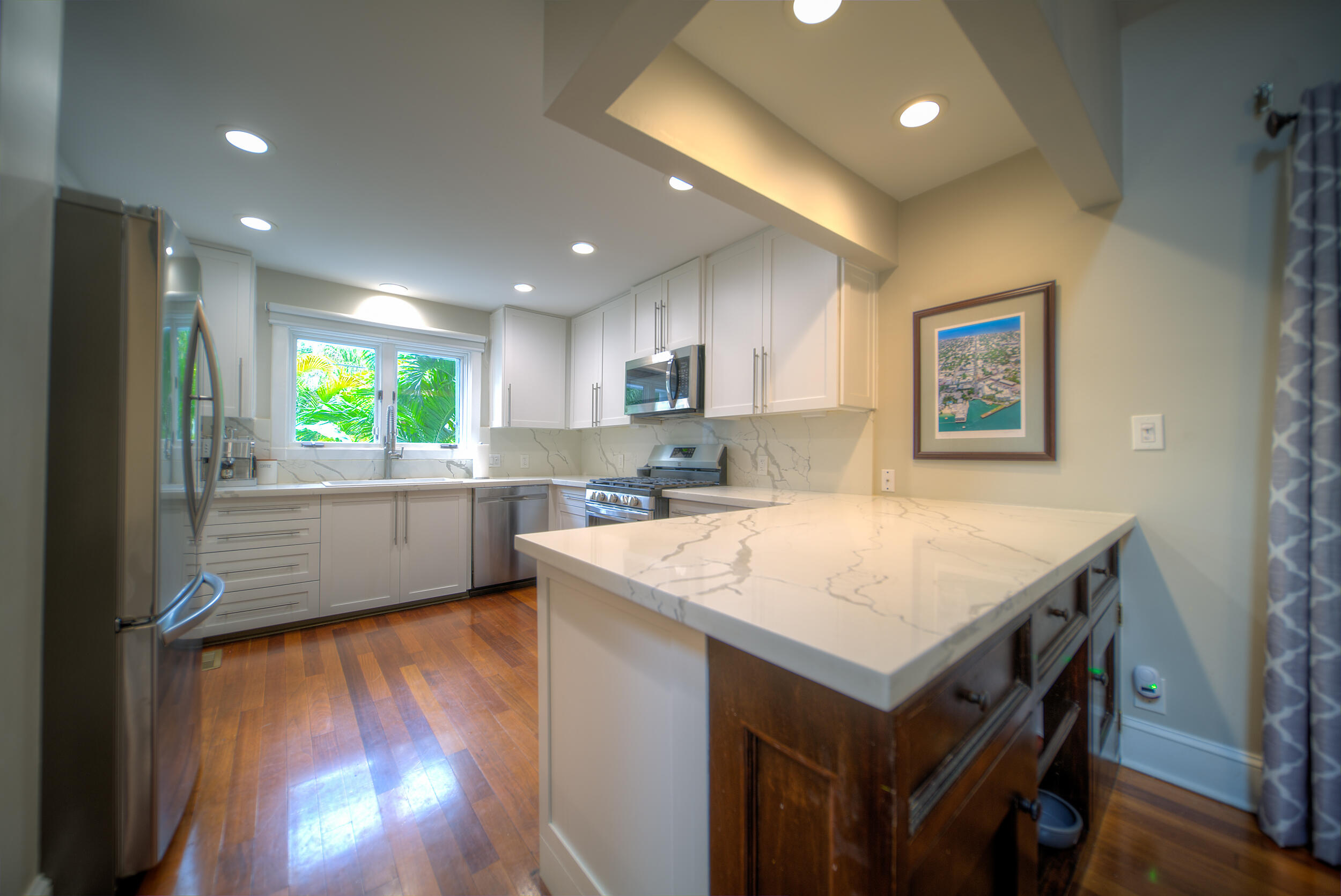 720 Washington Street Key West, FL 33040 - Photo 9 of 33 a kitchen with a stove a refrigerator and a microwave