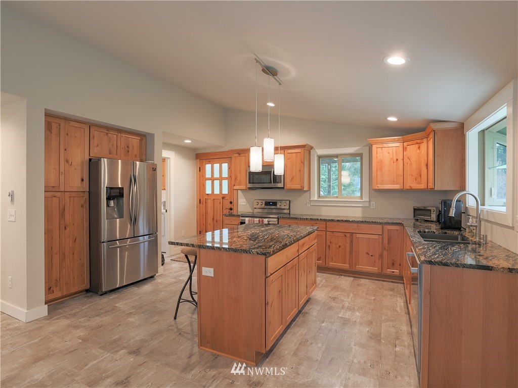 6102 River Valley Road Granite Falls, WA 98252 - Photo 5 of 21 a kitchen with stainless steel appliances granite countertop a stove top oven a refrigerator a sink and dishwasher