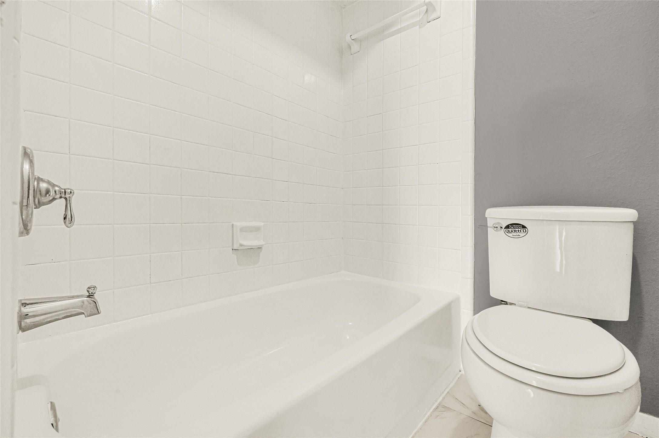 4170 Amir Street Houston, TX 77072 - Photo 11 of 18 a white toilet sitting next to a bath tub