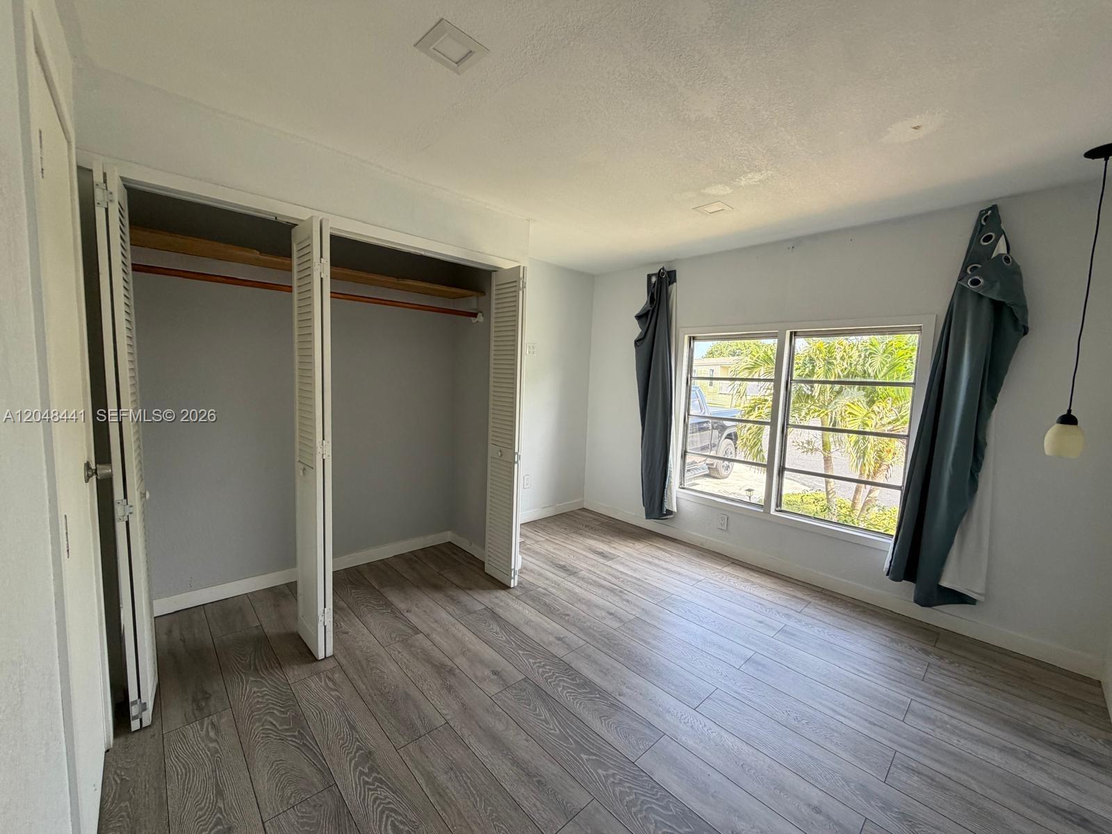 5331 Southwest 35th Street Davie, FL 33314 - Photo 11 of 31 an empty room with wooden floor and windows