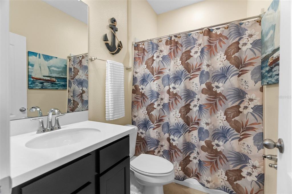 6283 Grapewood Road Spring Hill, FL 34609 - Photo 35 of 41 a bathroom with a sink toilet and shower