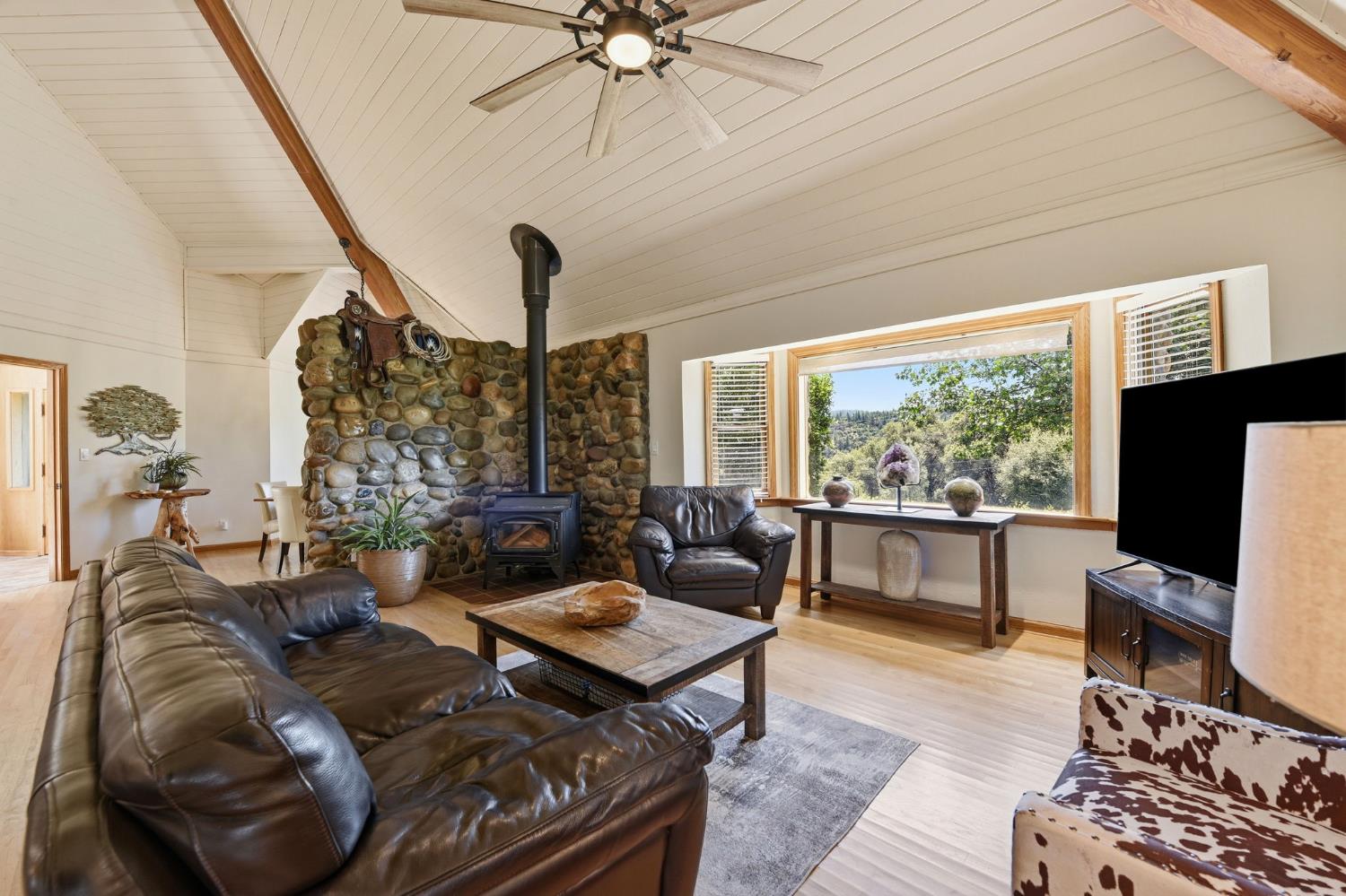 7201 Happy Valley Road Somerset, CA 95684 - Photo 13 of 75 The large picture bay window is a frame to the exterior forest and vineyard view outside.
