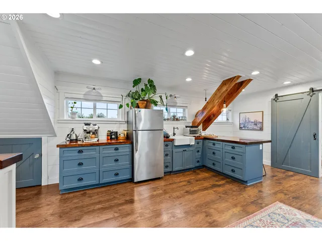 a kitchen view with wooden floor