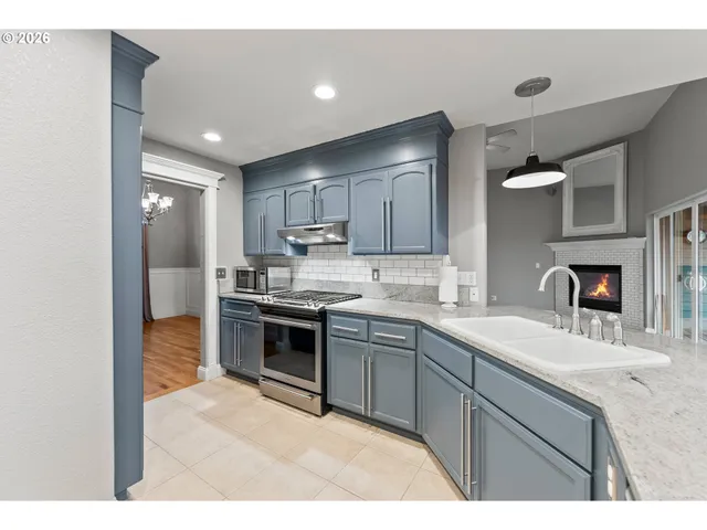 a kitchen with a sink stove and cabinets