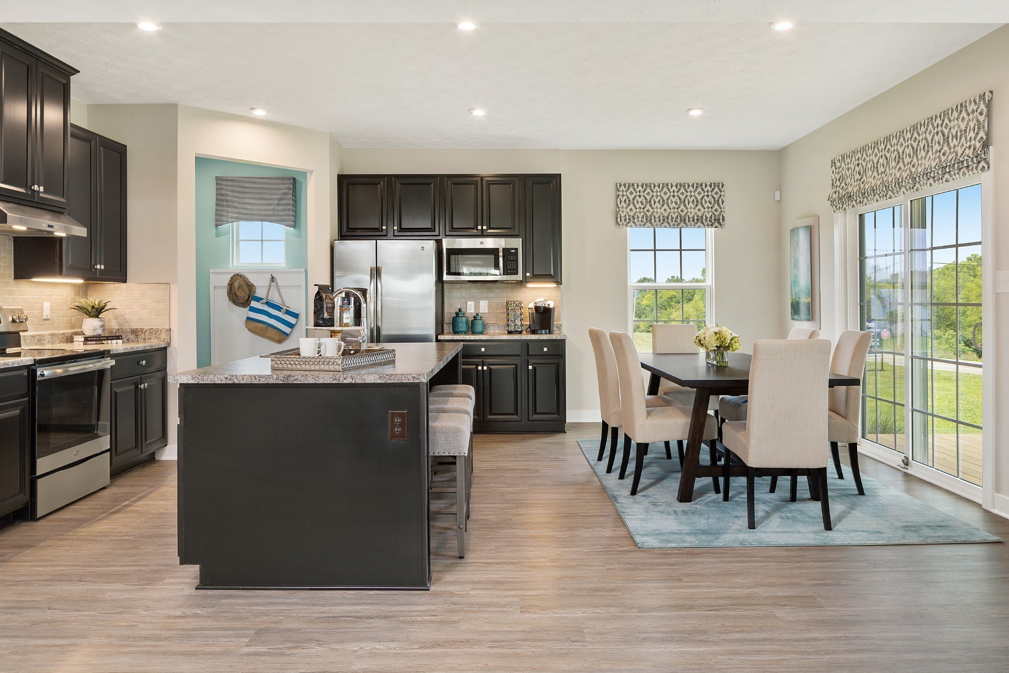 644 Castle Road Mount Juliet, TN 37122 - Photo 3 of 9 a dining hall with stainless steel appliances granite countertop a stove top oven a dining table and chairs