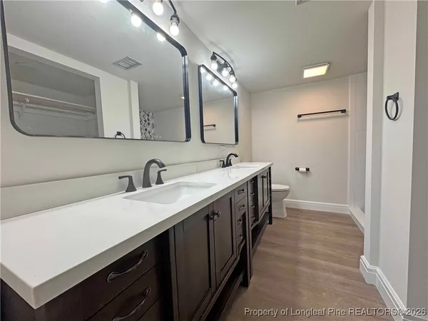 a bathroom with a double vanity sink and a mirror