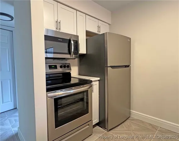 a kitchen with a stove microwave and refrigerator